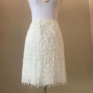 Festive fringed cream silk skirt.